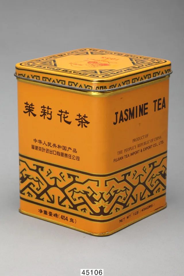 Museum collection photograph of a yellow jasmine tea tin showing 茉莉花茶, a company line and 454 克 near the bottom